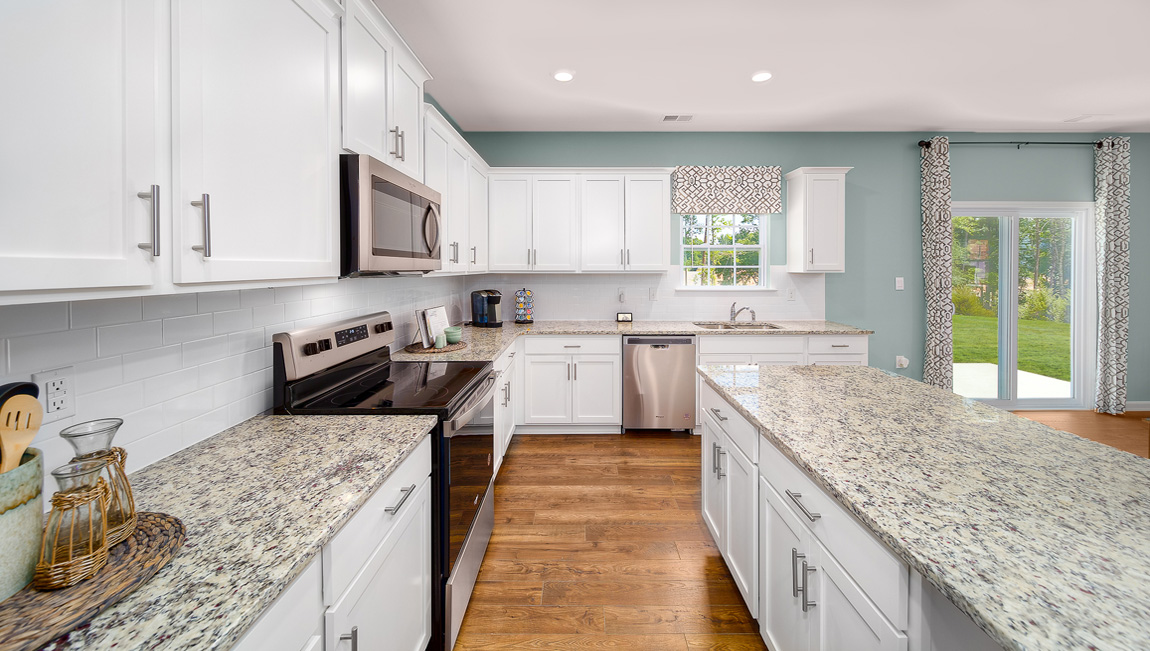 Kitchen and island with white cabinets and counters