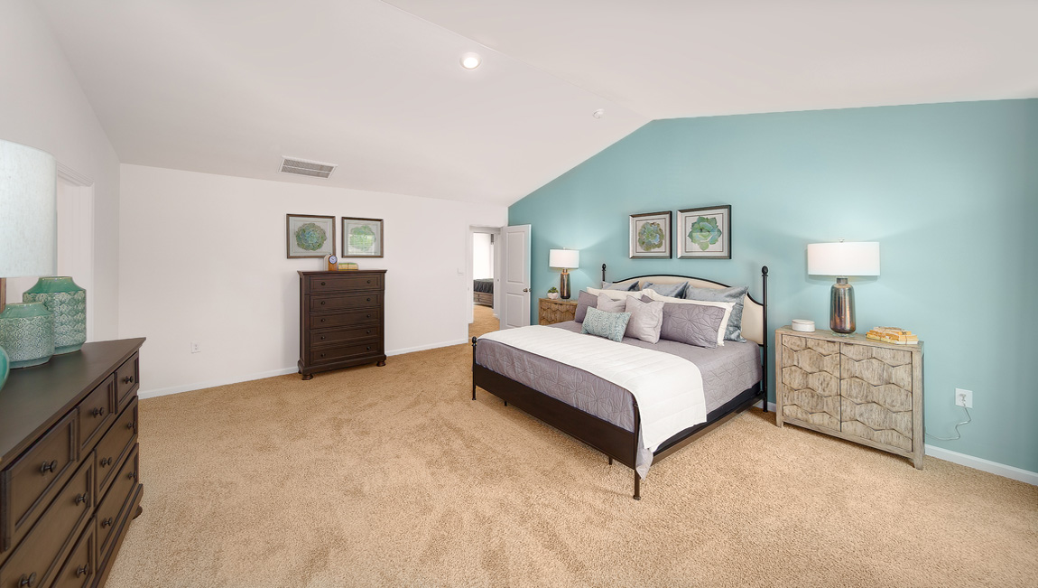 Primary suite, carpeted with two large windows