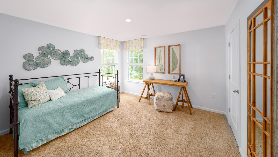 Carpeted bedroom with two large windows