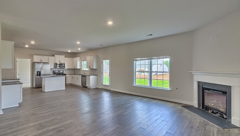 Spacious family room with large window and fireplace