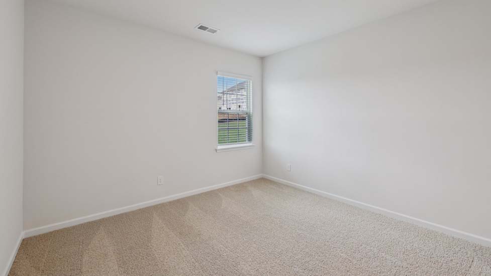Carpeted bedroom with windows
