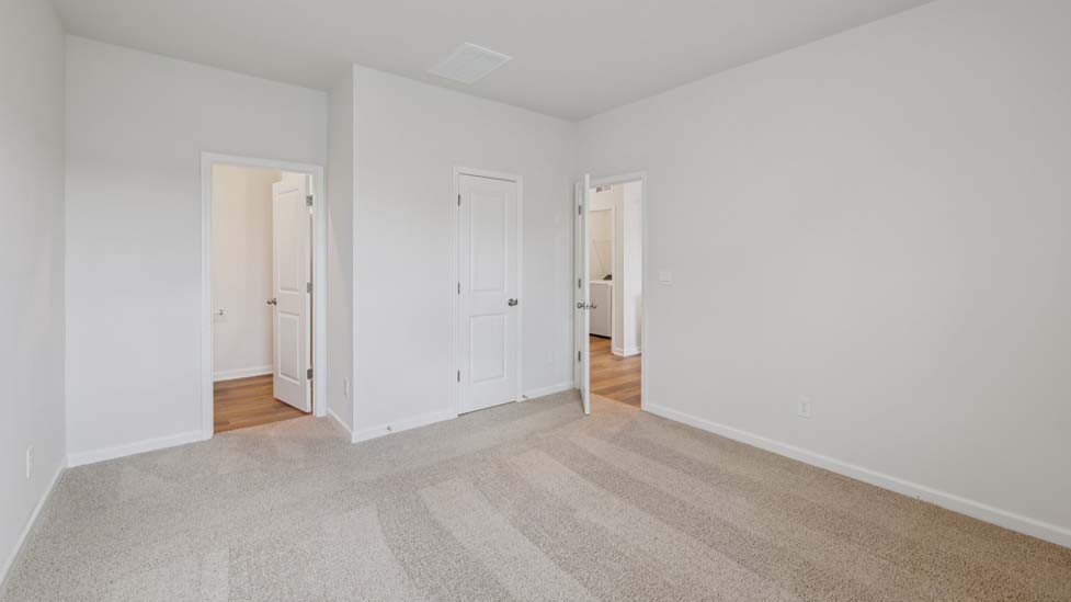 Carpeted bedroom with windows