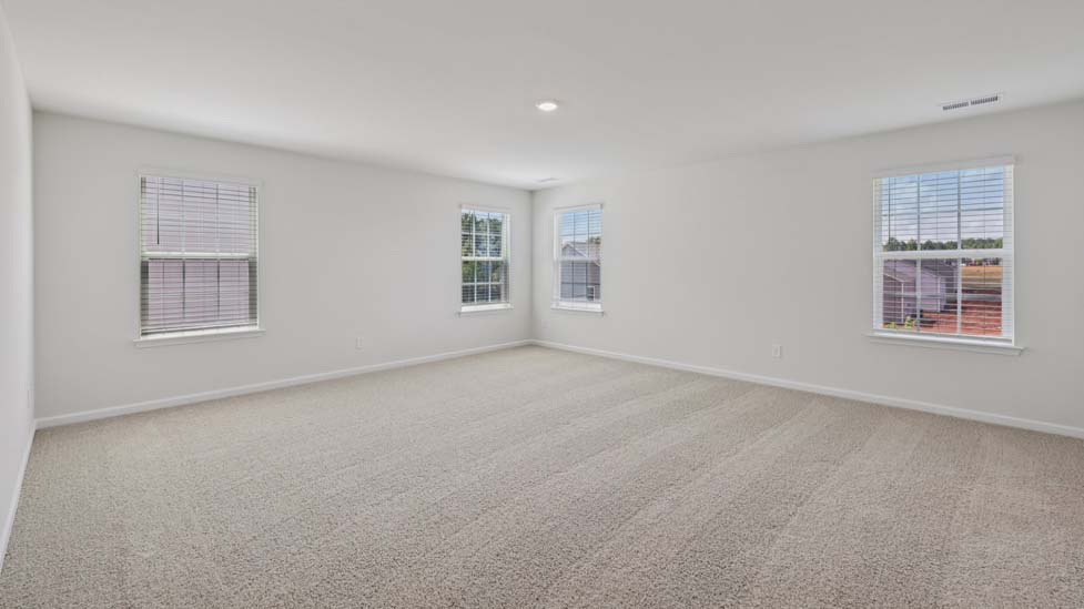 Carpeted bedroom with windows