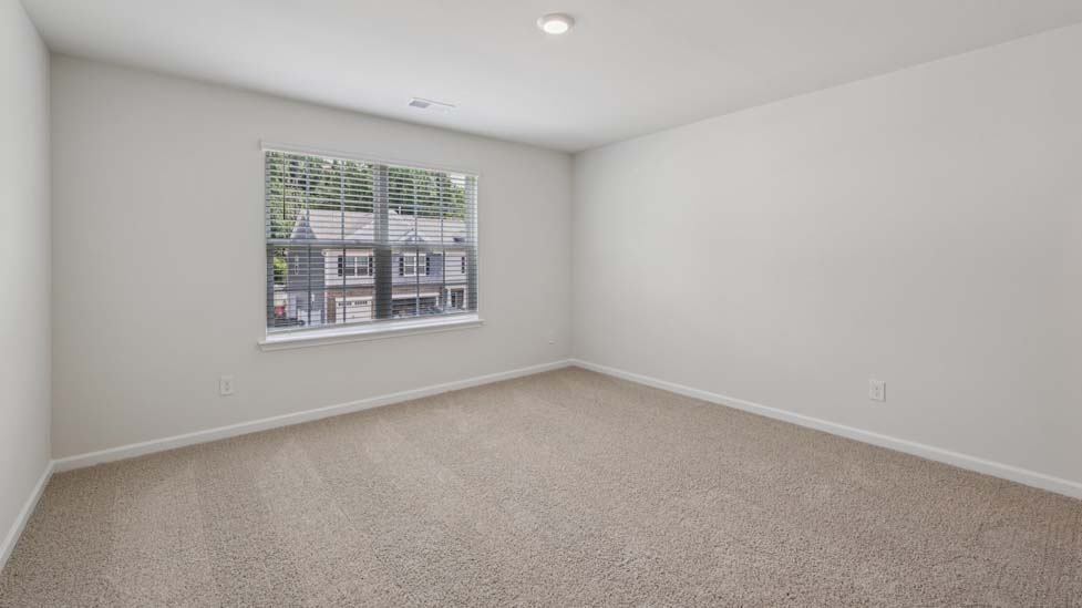 Carpeted bedroom with windows