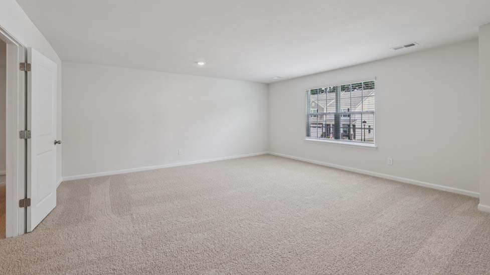Carpeted bedroom with windows