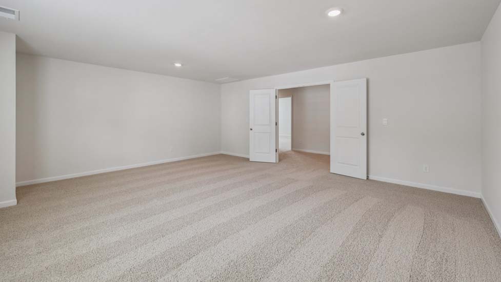 Carpeted bedroom with windows