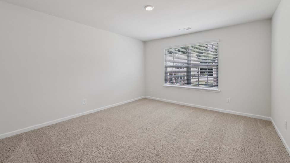 Carpeted bedroom with windows
