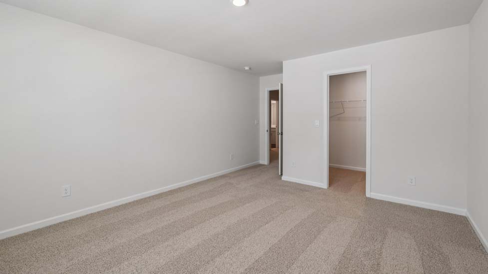 Carpeted bedroom with windows