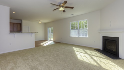 Family room with carpet, large window, and fireplace