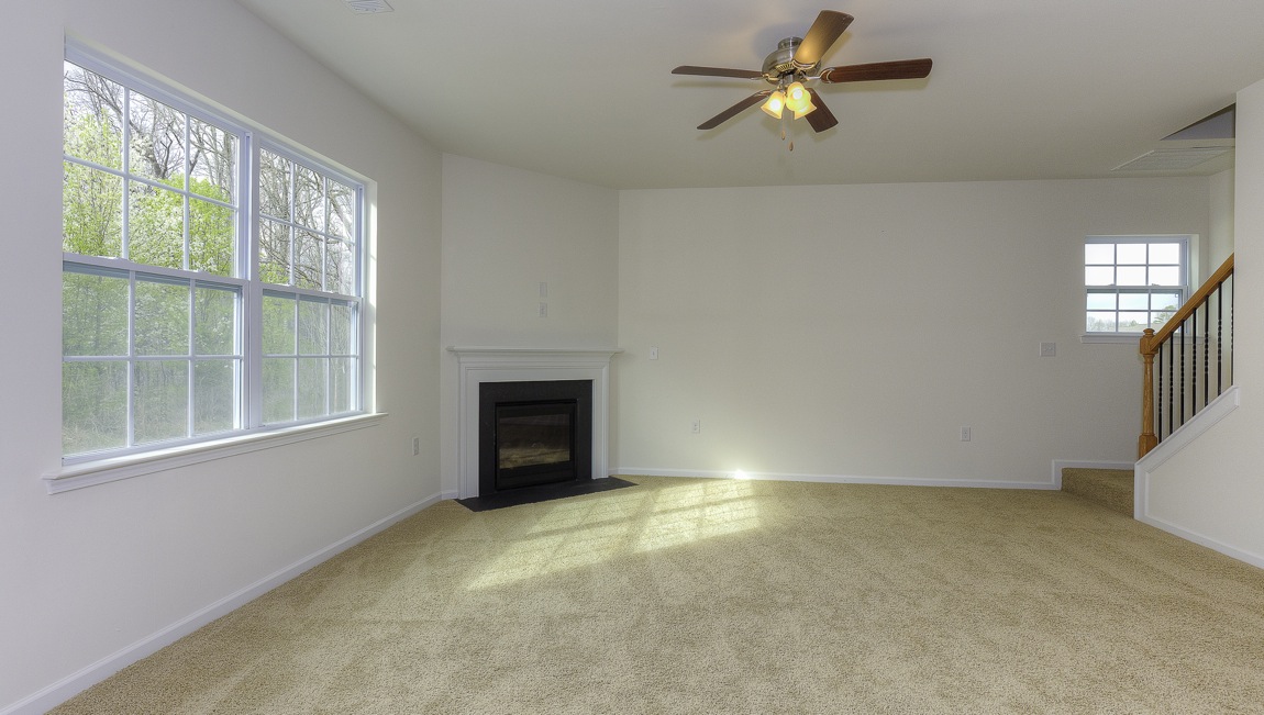 Family room with carpet, large window, and fireplace