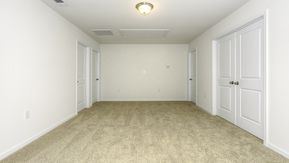 Carpeted loft atop staircase