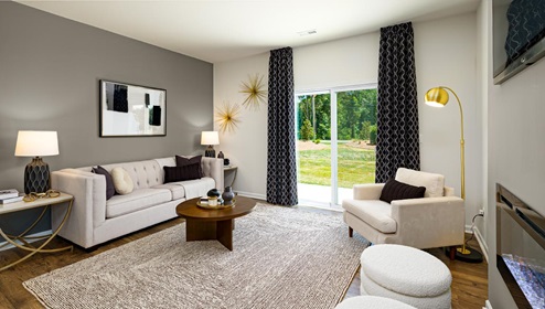 Living room with electric fire place, and sliding glass back door. New Home in Charlotte, North Carolina