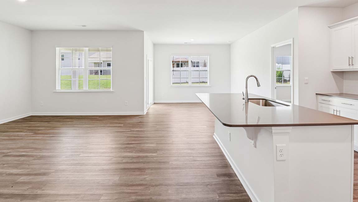 Kitchen and island with white cabinets, breakfast area at island, and stainless steel appliances