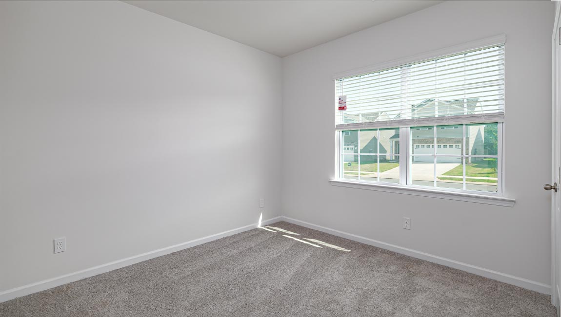Carpeted bedroom with large window