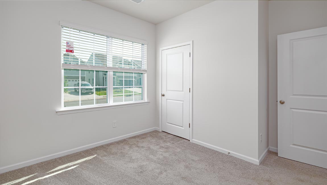 Carpeted bedroom with large window