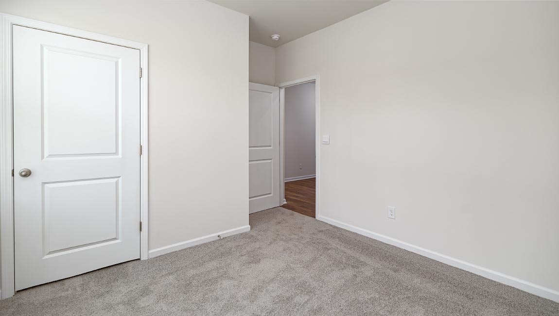 Carpeted bedroom with large window