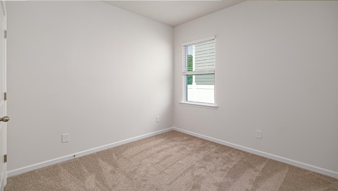 Carpeted bedroom with large window