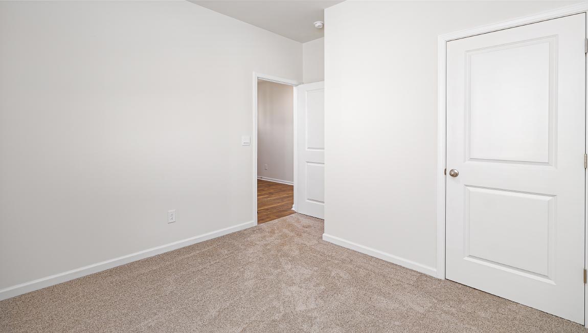 Carpeted bedroom with large window