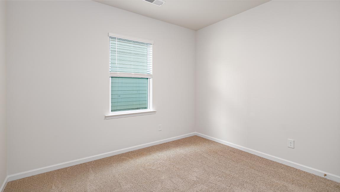 Carpeted bedroom with large window
