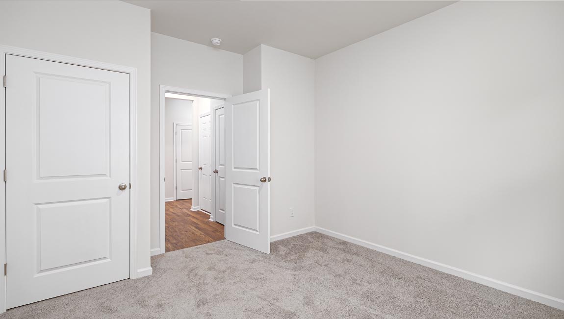 Carpeted bedroom with large window