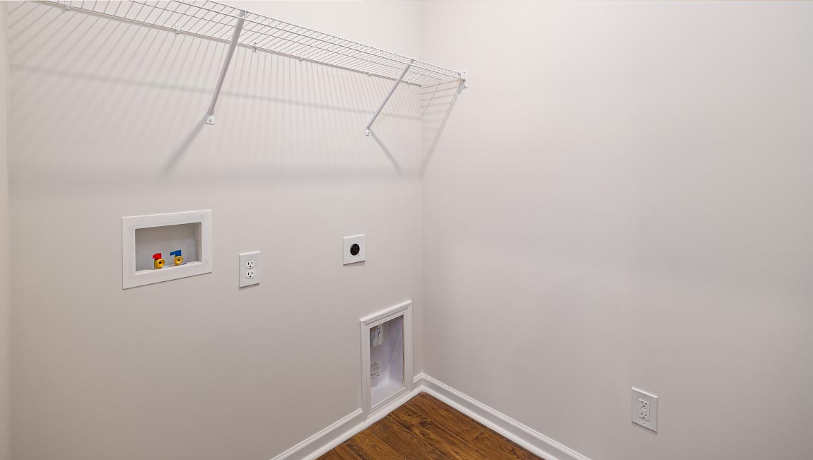 Laundry room with storage and hanging racks above machines
