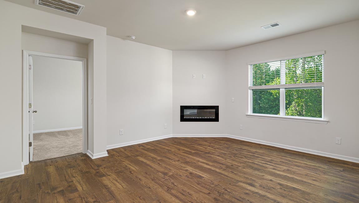 Open living room with ceiling fan and large window