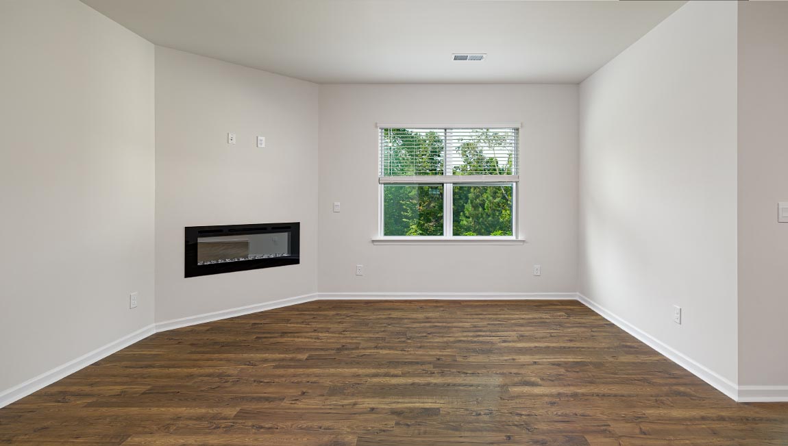 Open living room with ceiling fan and large window