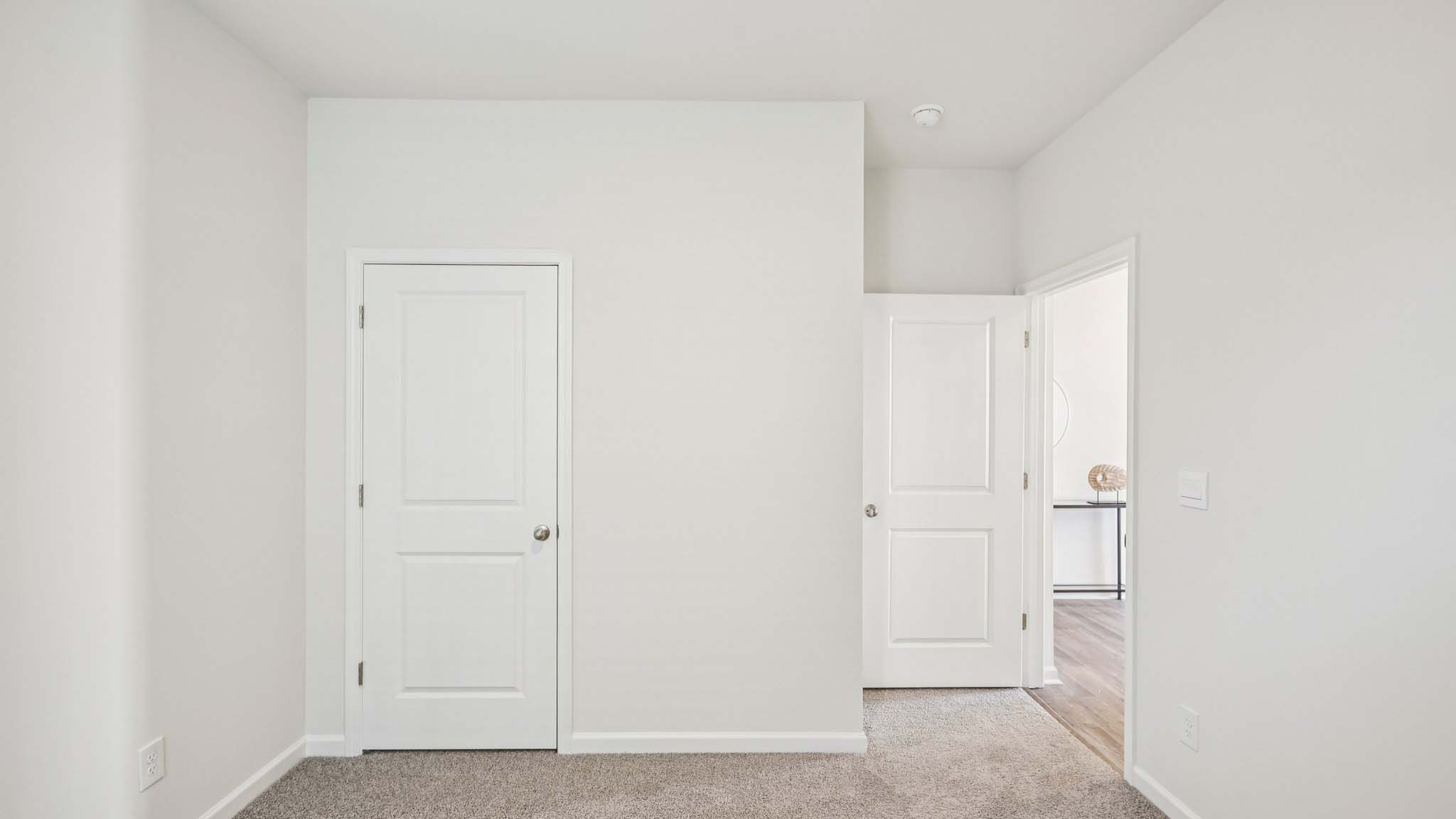 Carpeted bedroom with large window