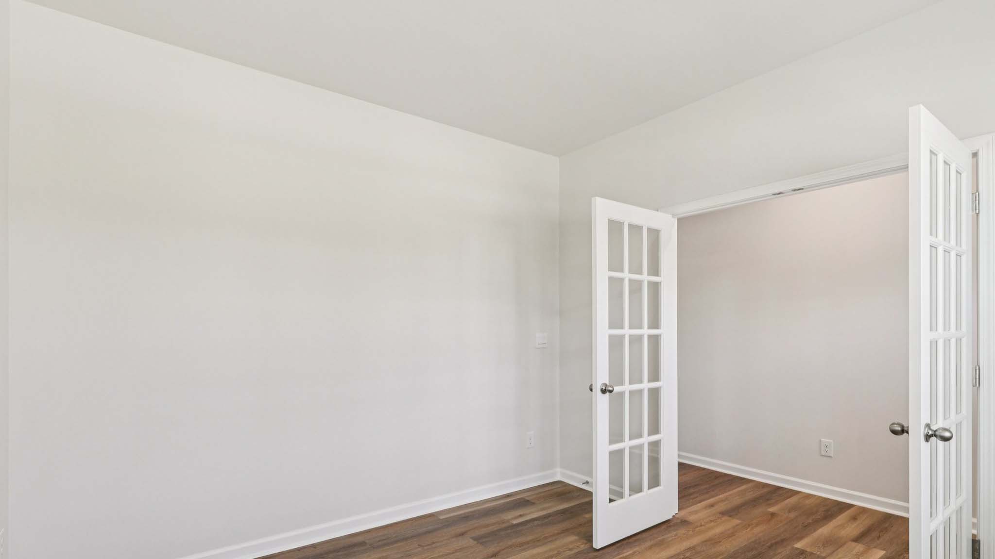 Flex office space with hardwood flooring, large window and french doors