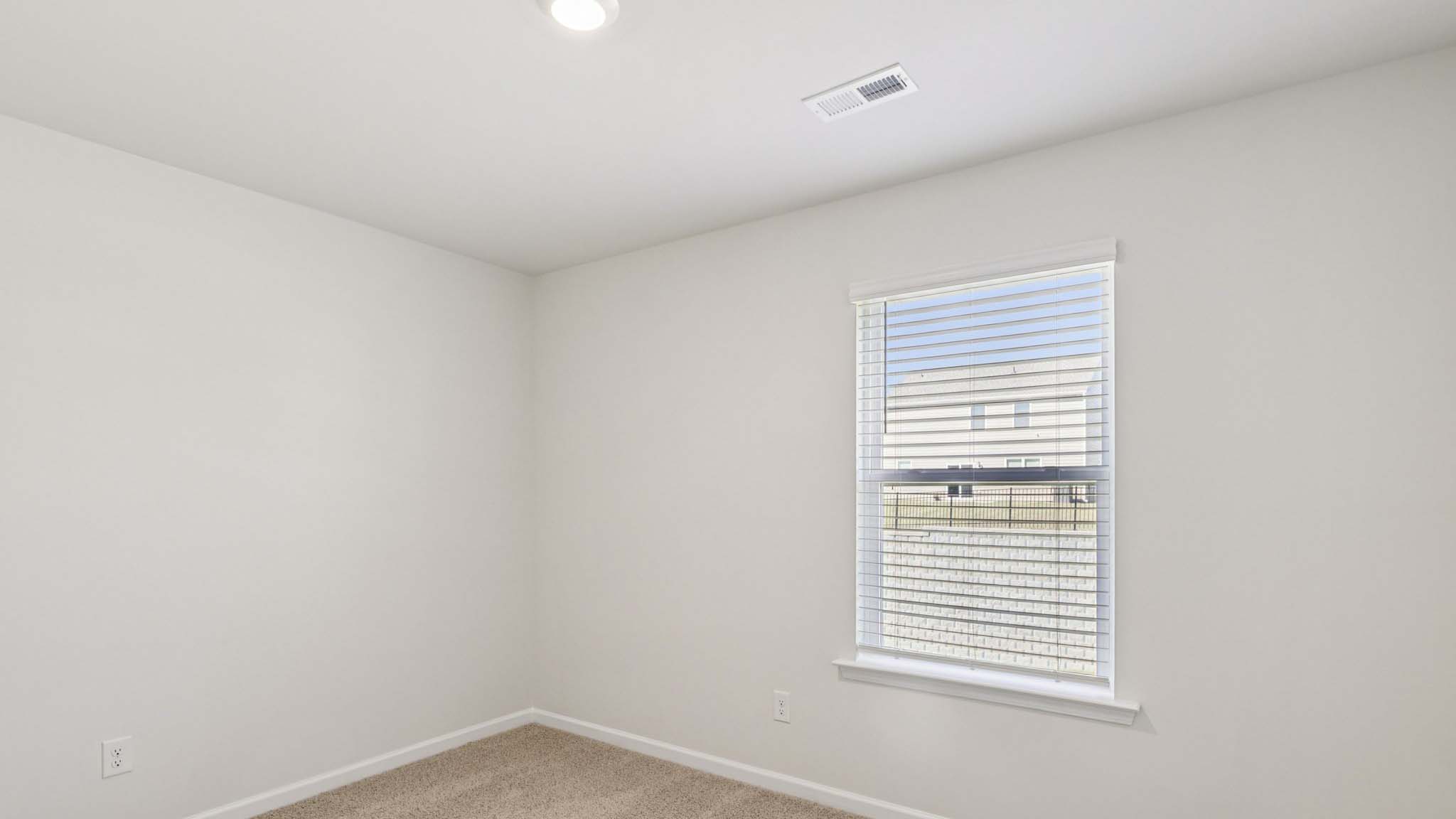 carpeted bedroom with large window