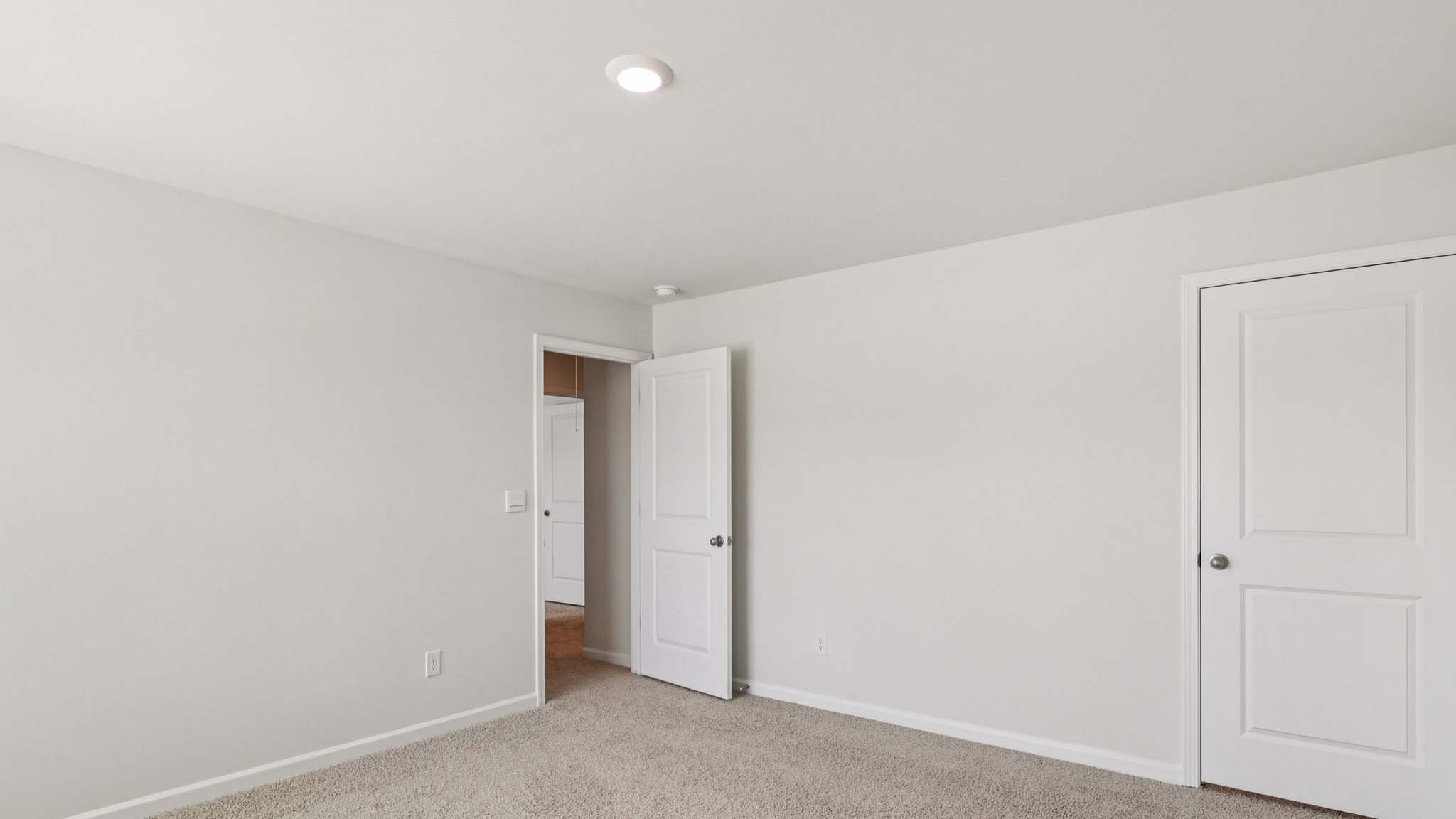 carpeted bedroom with large window