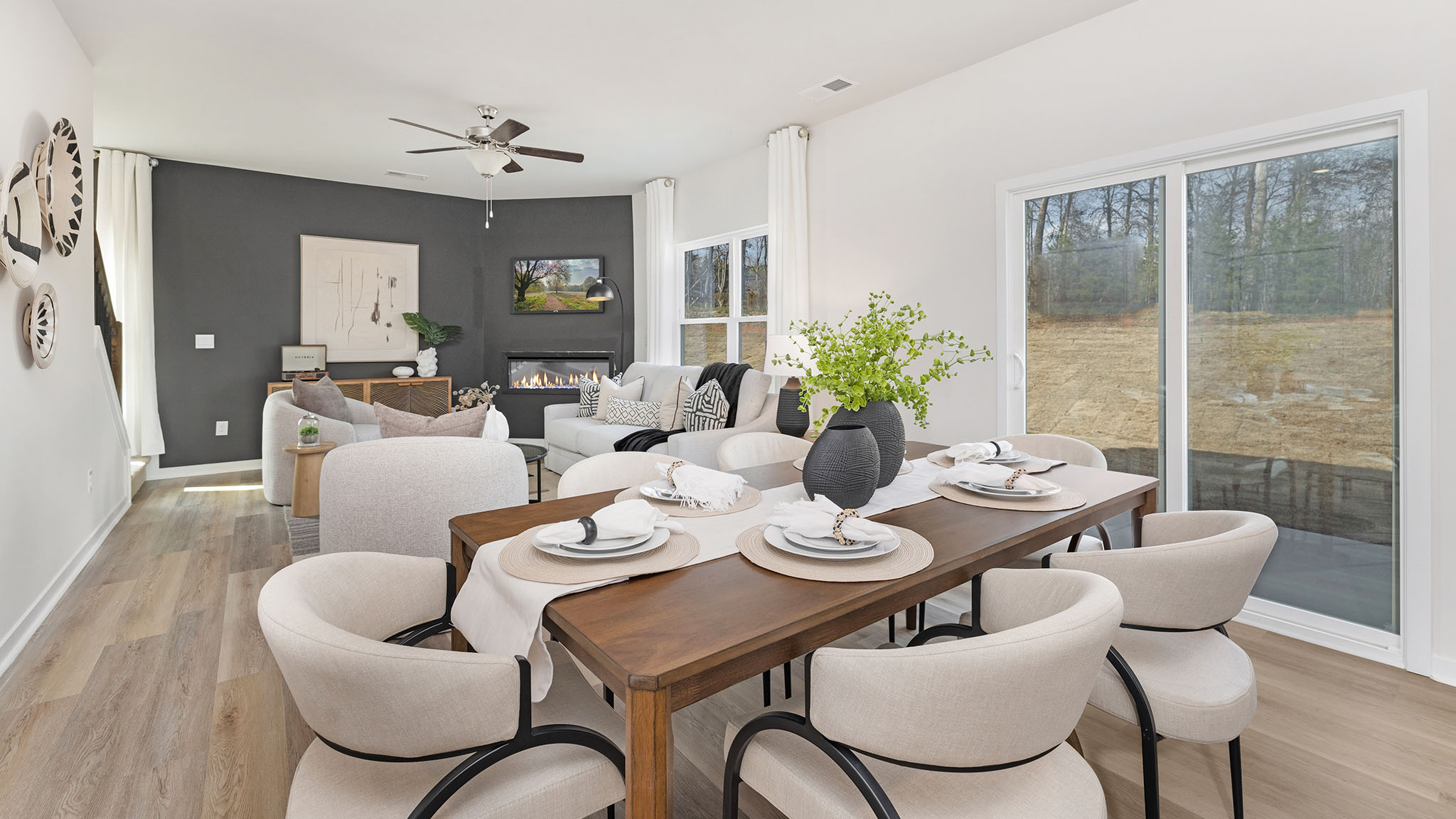 Open greatroom  beside kitchen, against staircase, with large window