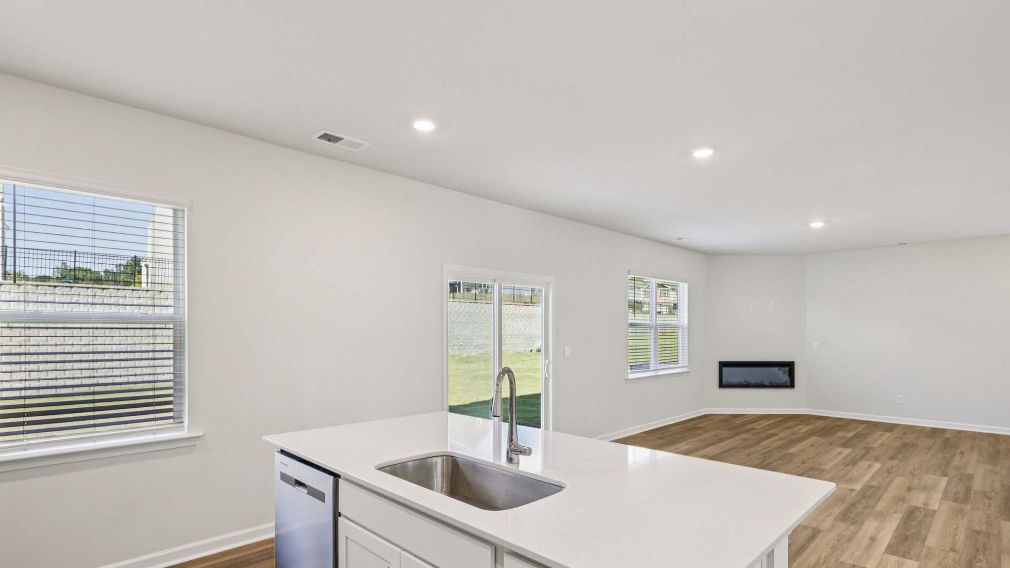Kitchen with island, white cabinets and wood floors
