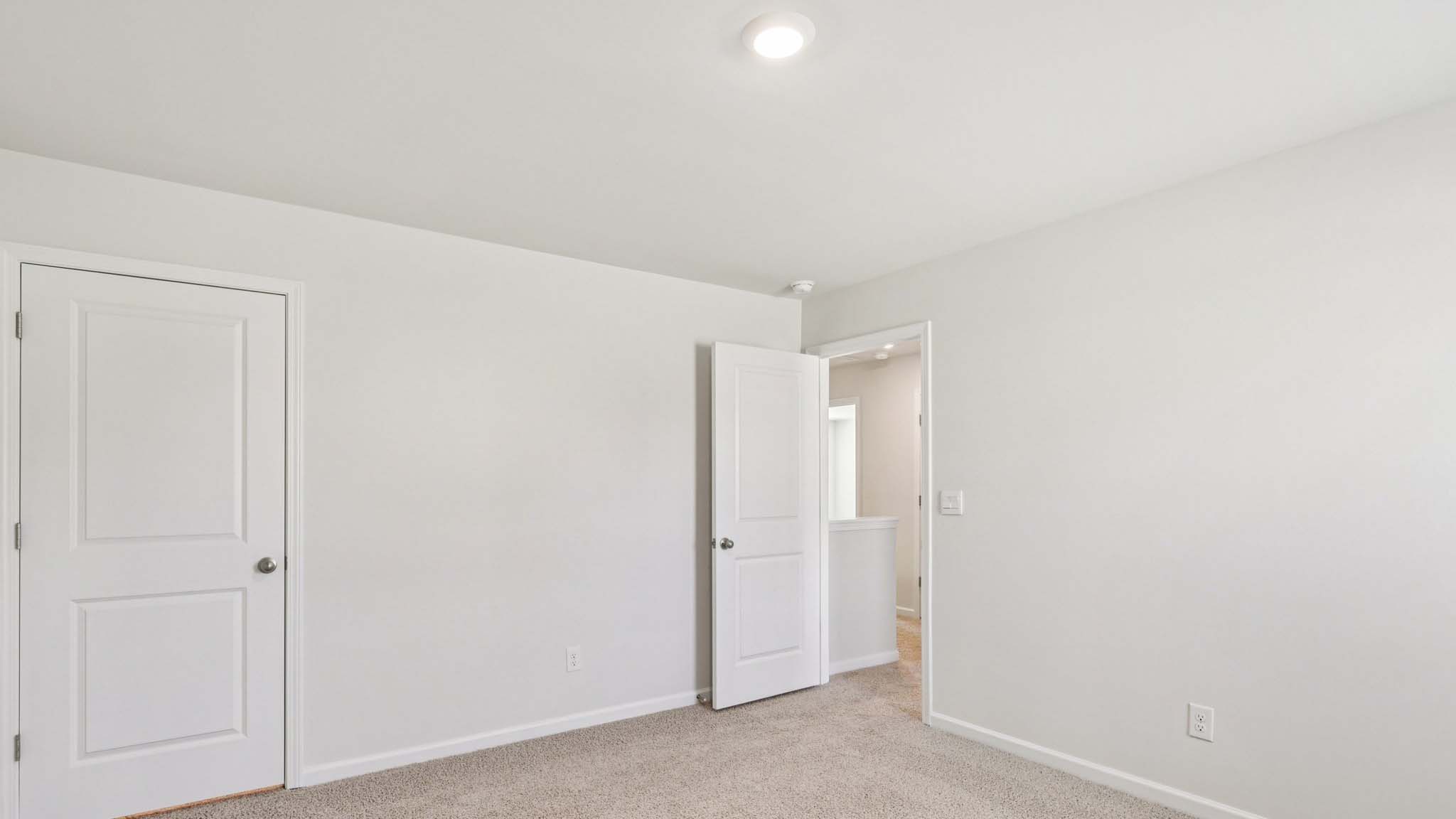 carpeted bedroom with large window