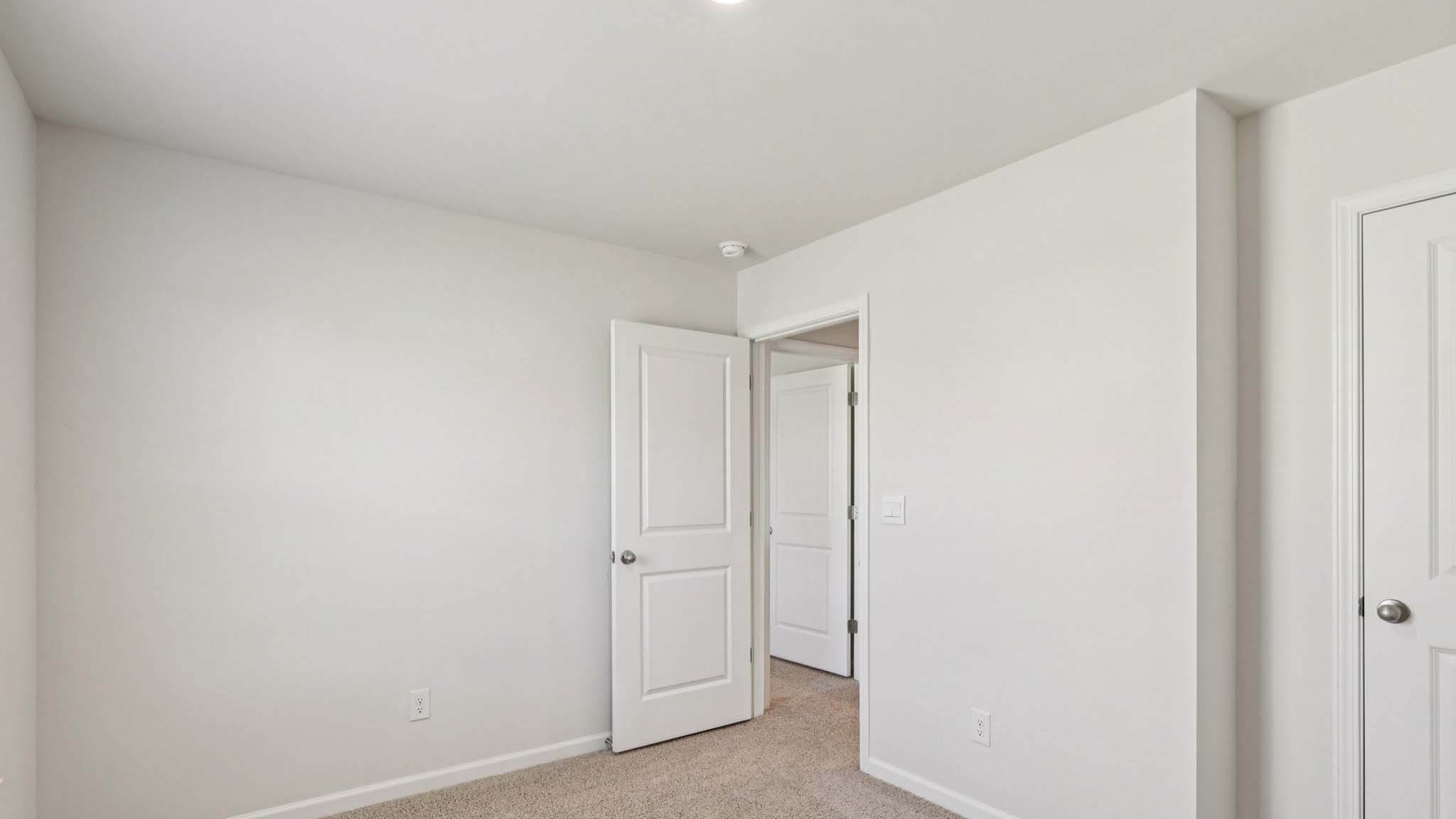 carpeted bedroom with large window