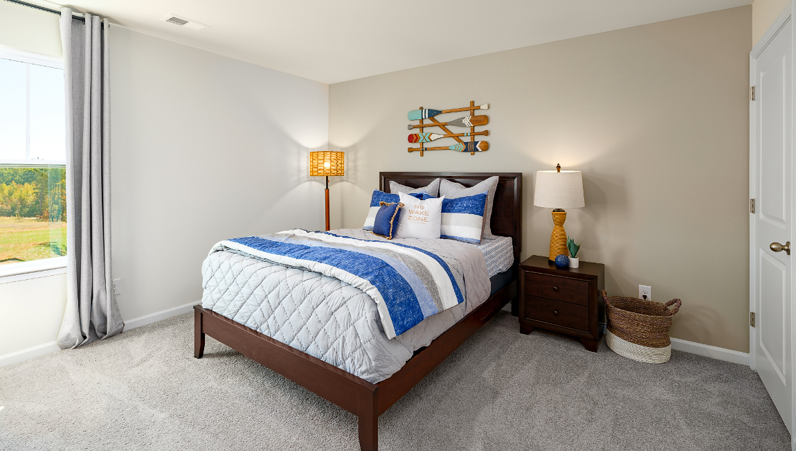 carpeted bedroom with large window
