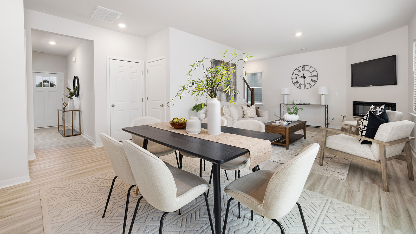 Open greatroom  beside kitchen, against staircase, with large window
