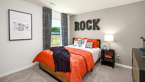 Carpeted bedroom with small window