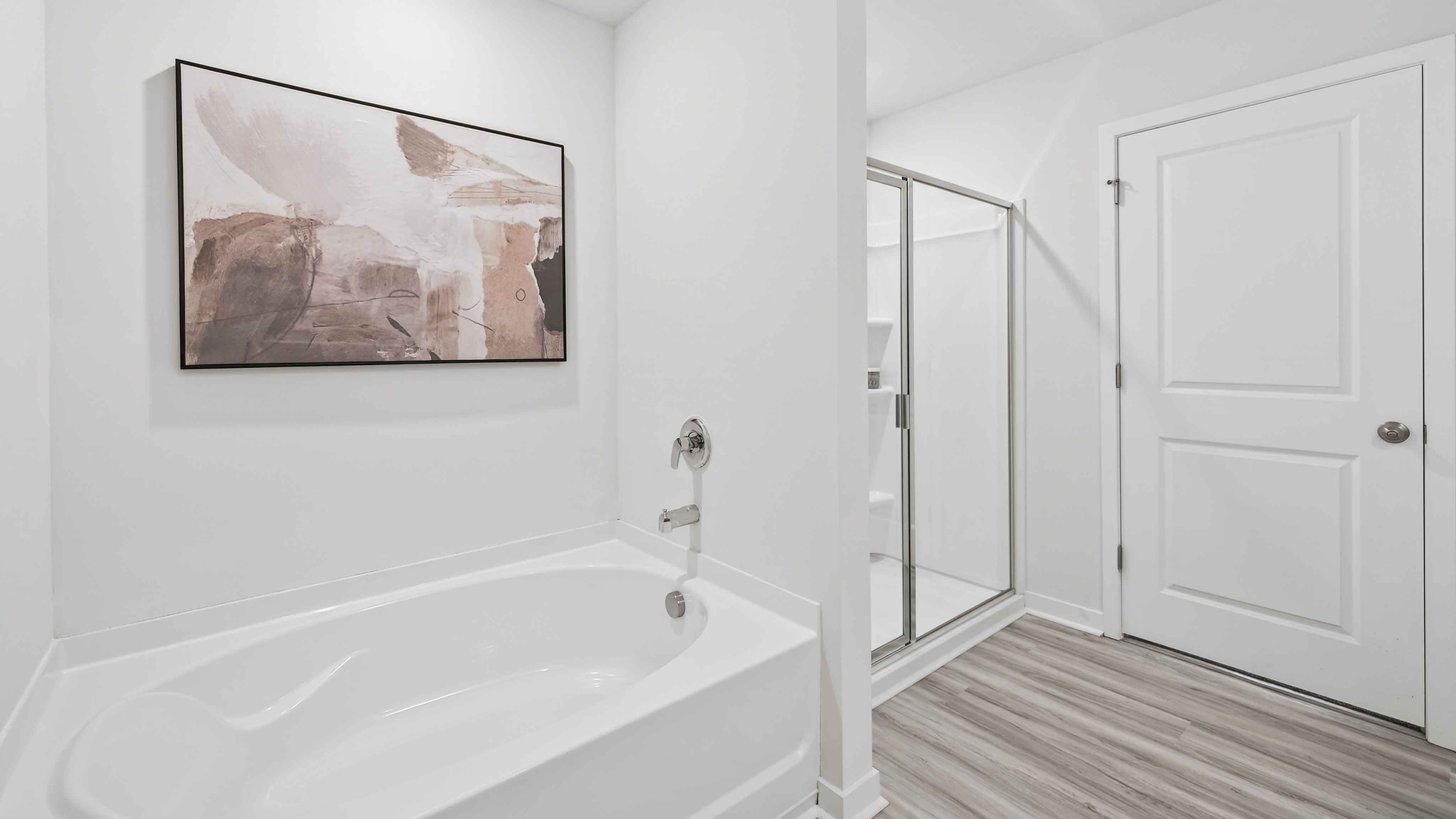 Primary bathroom with double sinks, white cabinets and counters