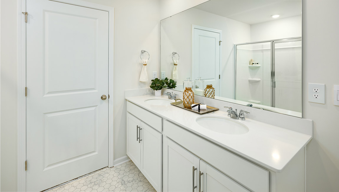 Primary bathroom with double sink vanity and large shower