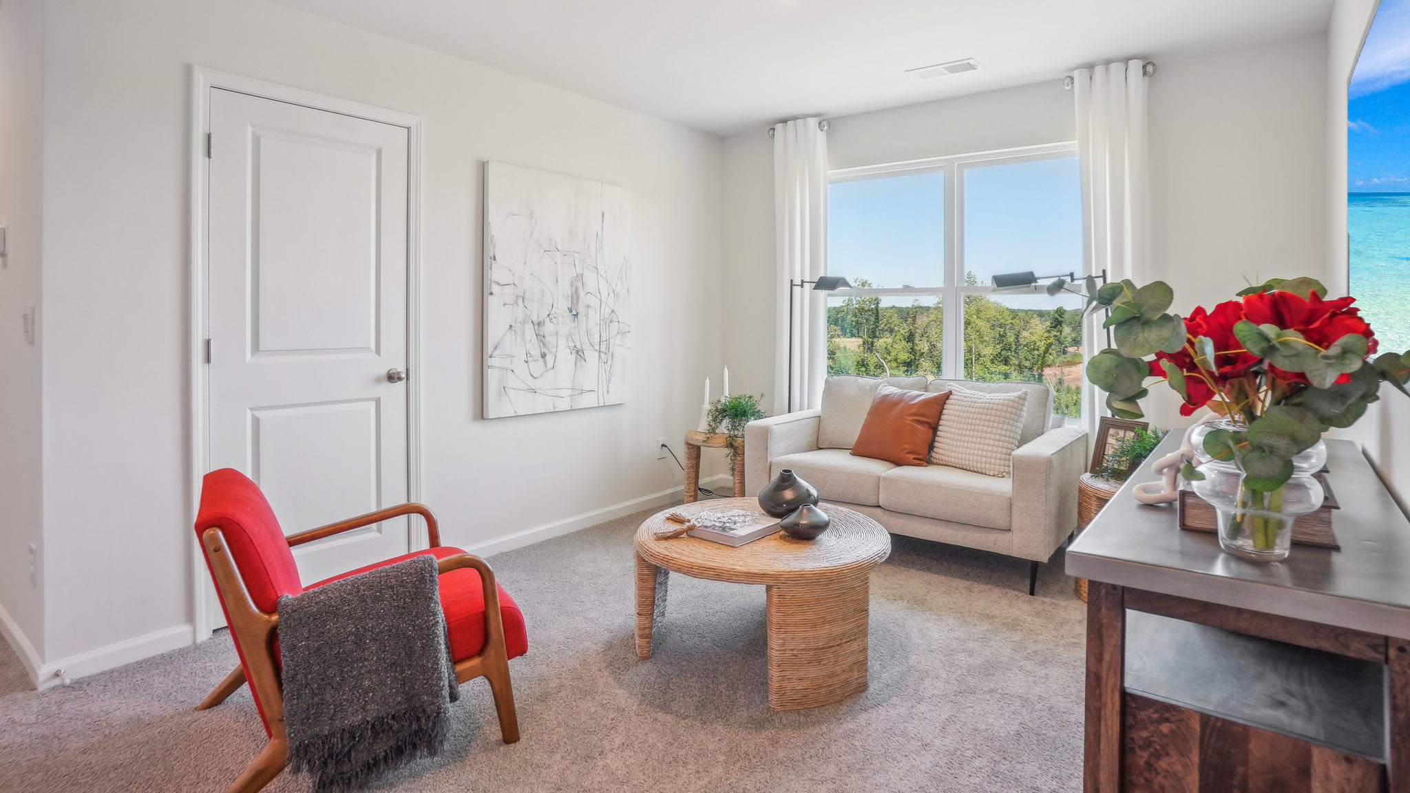 carpeted bedroom with large window