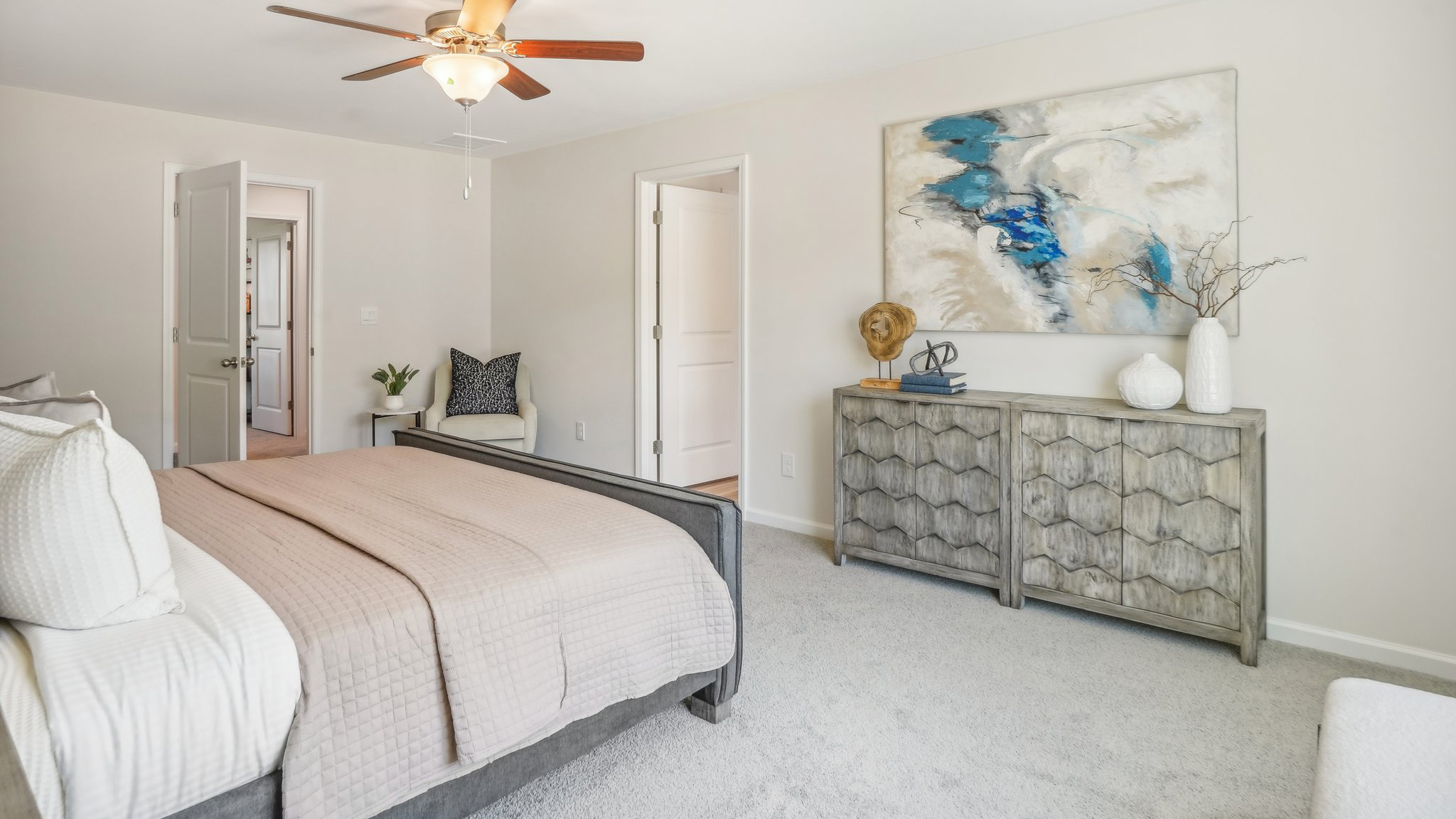 primary carpeted bedroom with large window
