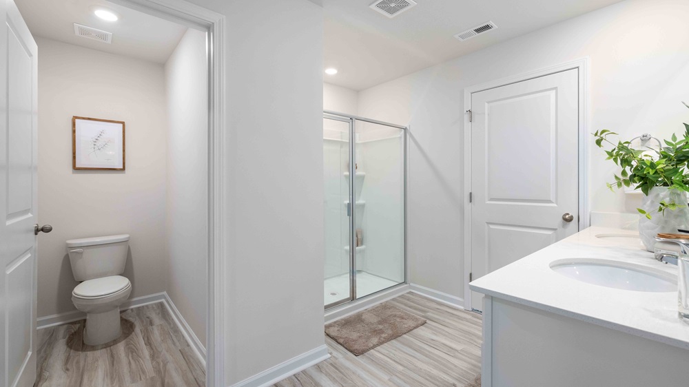 Primary bathroom with double sink vanity and large shower
