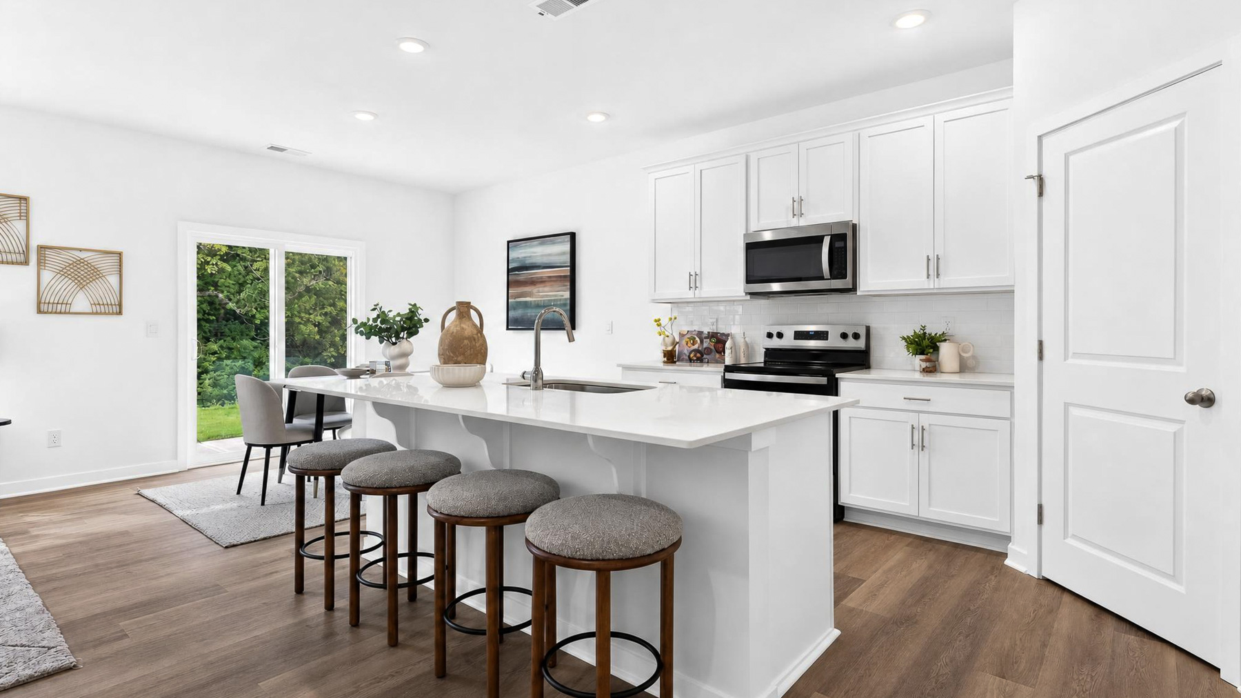 Kitchen and island with stainless appliances