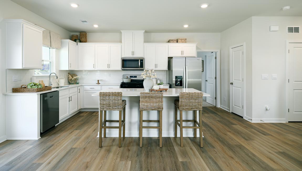 Kitchen and island with white counters and cabinets