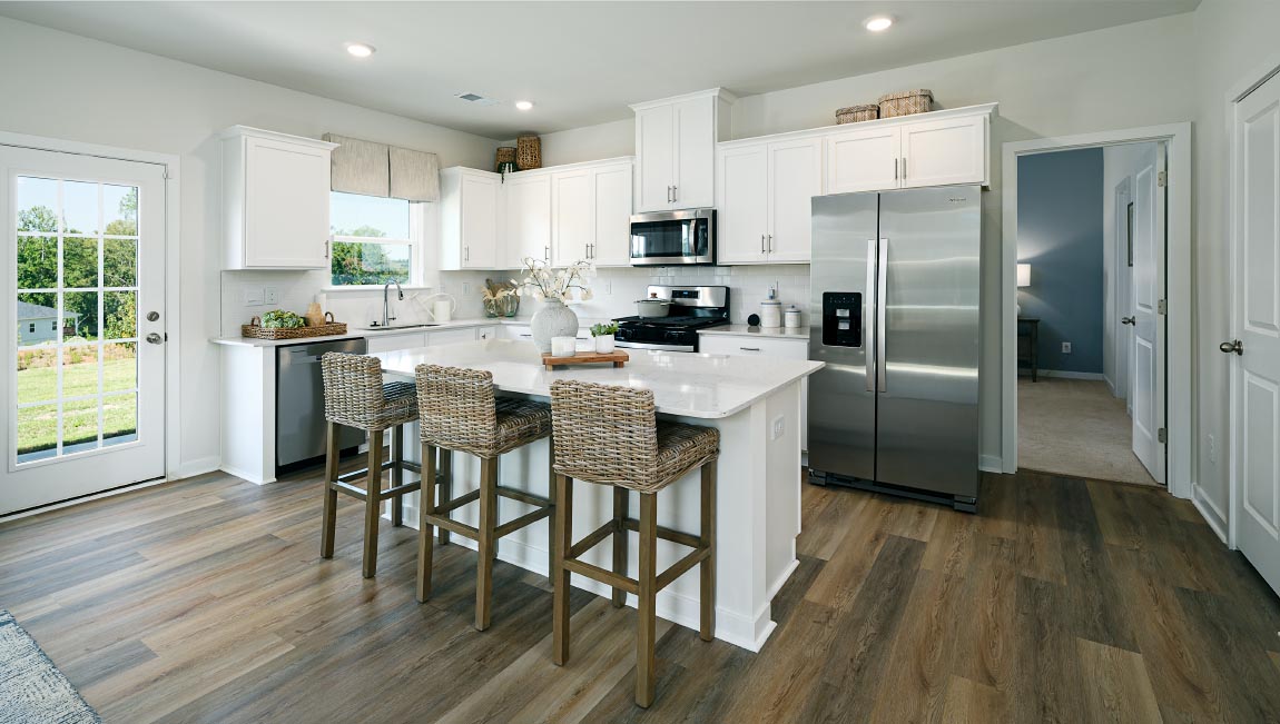 Kitchen and island with white counters and cabinets