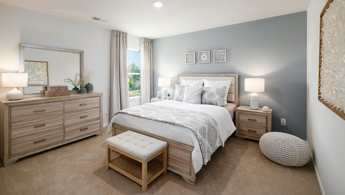 Carpeted bedroom with windows