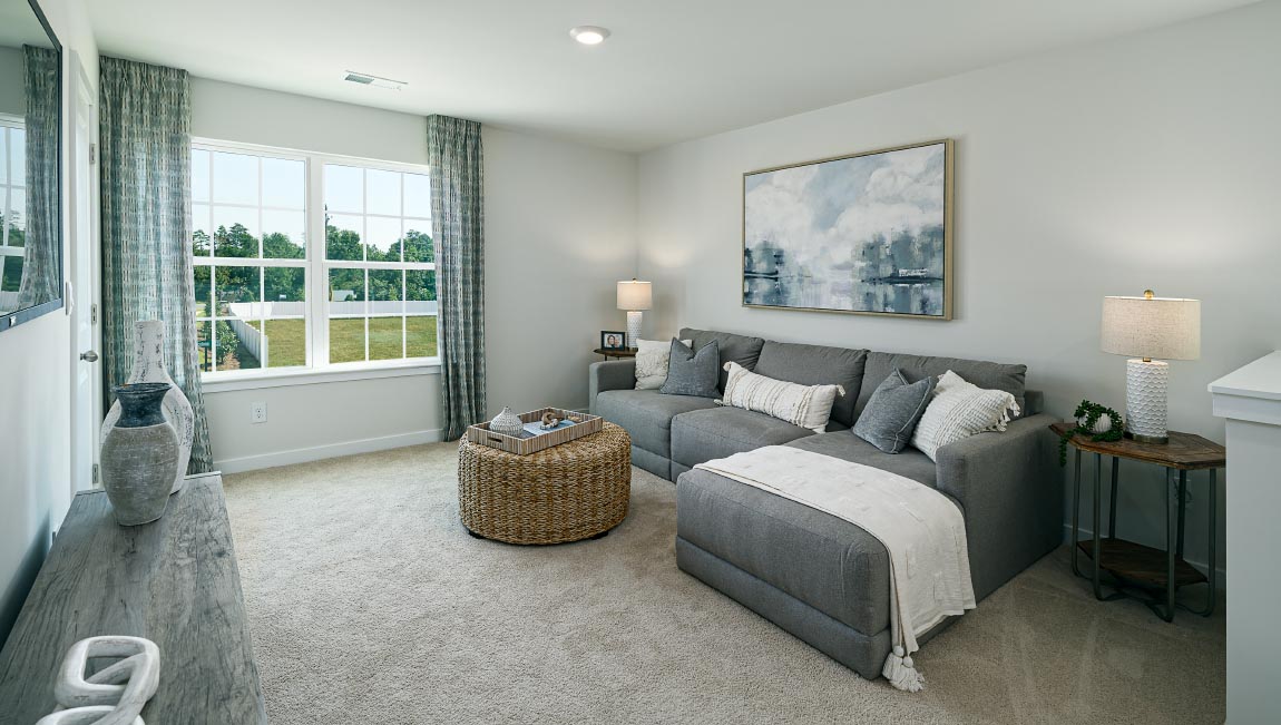 Carpeted bedroom with windows