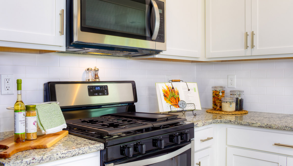 Kitchen and island with white cabinets