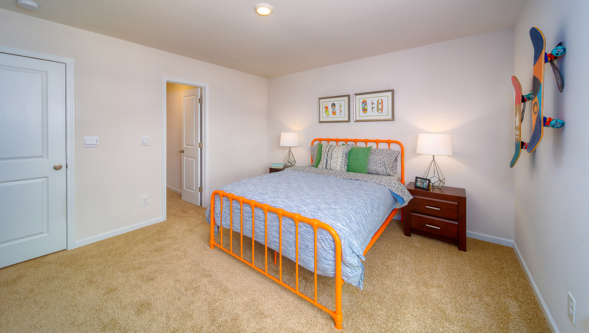 Carpeted bedroom with large window